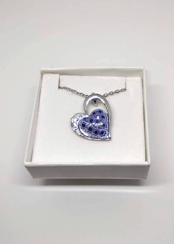 A lovely heart-shaped necklace with a pop of indigo flowers in the middle, made with the millefioritechnique.