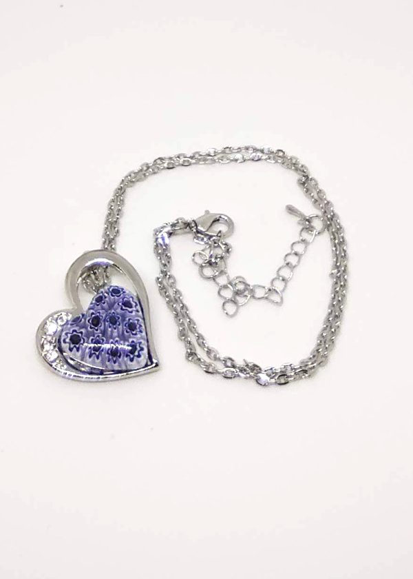 A lovely heart-shaped necklace with a pop of indigo flowers in the middle, made with the millefioritechnique.