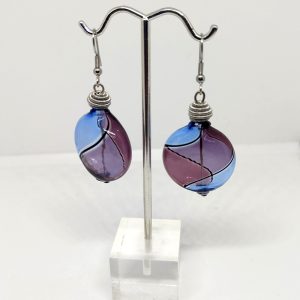 Sky blue, purple and black lines swirl around in these Murano glass earings. Each earring is stopped with metallic coil. 