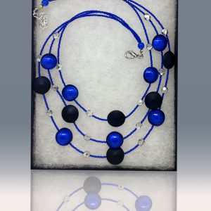 A three-tiered necklace made of gorgeous black beads peppered and fused with fragments of blue glass.