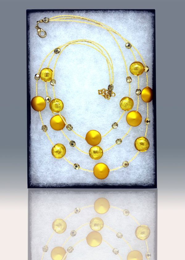 A three-tiered necklace made of gorgeous golden-yellow beads peppered and fused with fragments of yellow glass.