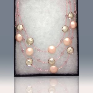 A three-tiered necklace made of gorgeous delicate-pink beads peppered and fused with fragments of light pink glass.