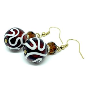 Calliope is a unique pair of earrings, with an an overlay of raised white glass in a swirl pattern, topped off with a bright red glass bead.