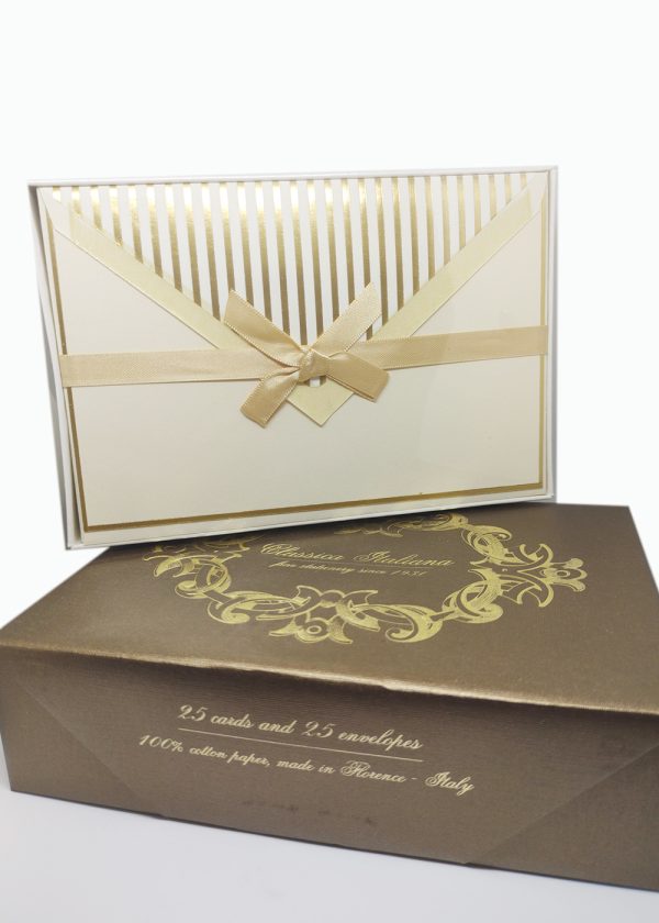Elegant scene featuring two elements. At the bottom, there's a luxurious copper-gold box. On top of this regal box, there's another container, slightly smaller, which includes the set of 25 cards and 25 envelopes.