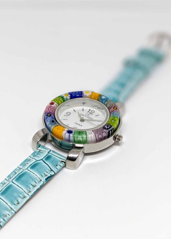The watch is made with the center of Murano glass using the Millefiori (thousand-flowers) technique, in which thin rods of glass (called murrine) are carefully inserted in a pattern and then heated until they fuse together, forming the circlet around the watch face. The watchband is in turquoise blue color.