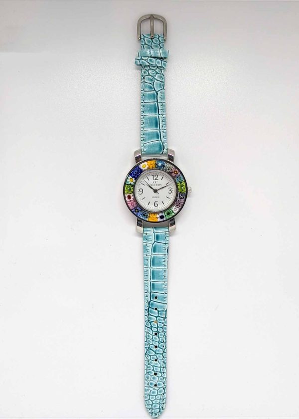 The watch is made with the center of Murano glass using the Millefiori (thousand-flowers) technique, in which thin rods of glass (called murrine) are carefully inserted in a pattern and then heated until they fuse together, forming the circlet around the watch face. The watchband is in turquoise blue color.