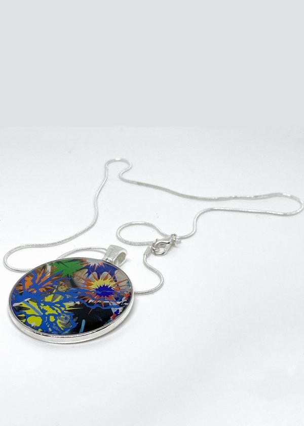 This necklace has a center circular pendant that reflects one of Kara Maria’s paintings—an abstract splash of multiple colors with a small butterfly in the middle.