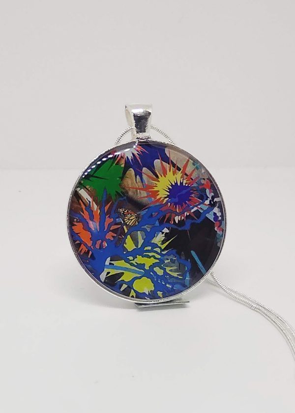 This necklace has a center circular pendant that reflects one of Kara Maria’s paintings—an abstract splash of multiple colors with a small butterfly in the middle.