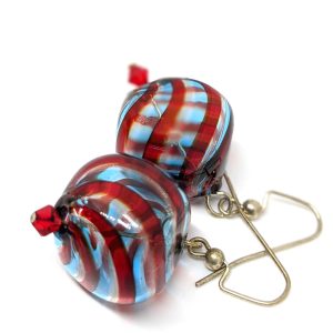Murano glass drop earrings with light blue and red stripes on clear hand-blown glass, with a small red bead at the end.