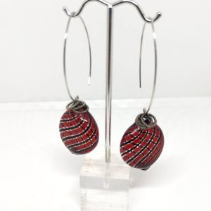 Glass drop earrings with a deep red and black lines beads and metal coil