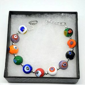 This bracelet is done with 11 unique glass beads, each one crafted with traditional millefiori technique, where thin rods of glass called murrine are carefully arranged in a pattern and then heated until they fuse together. 